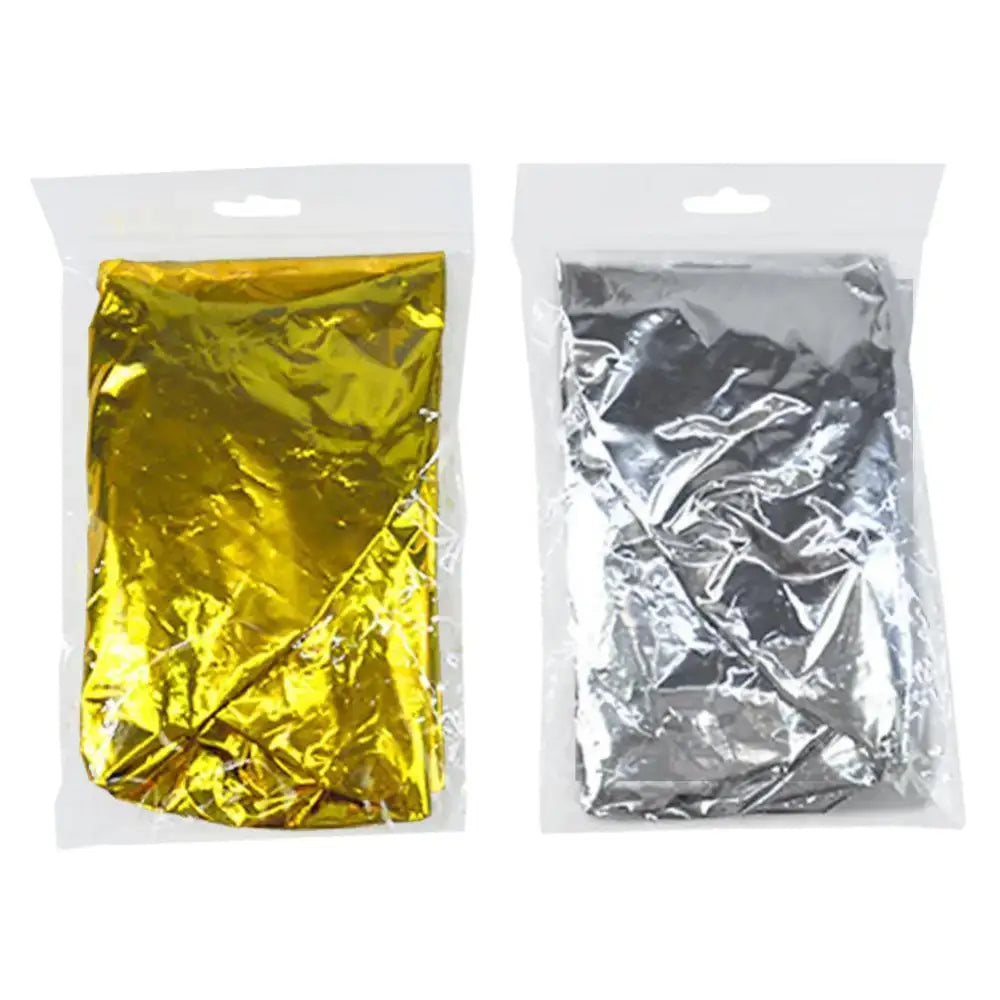 Two sealed plastic bags containing metallic foil sheets in gold and silver colors.