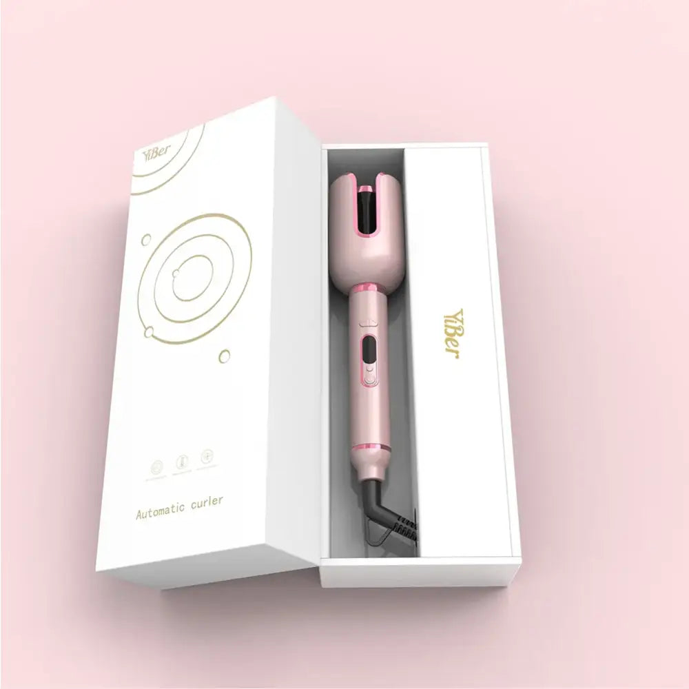 Pink hair curling or styling tool in an open white box packaging.