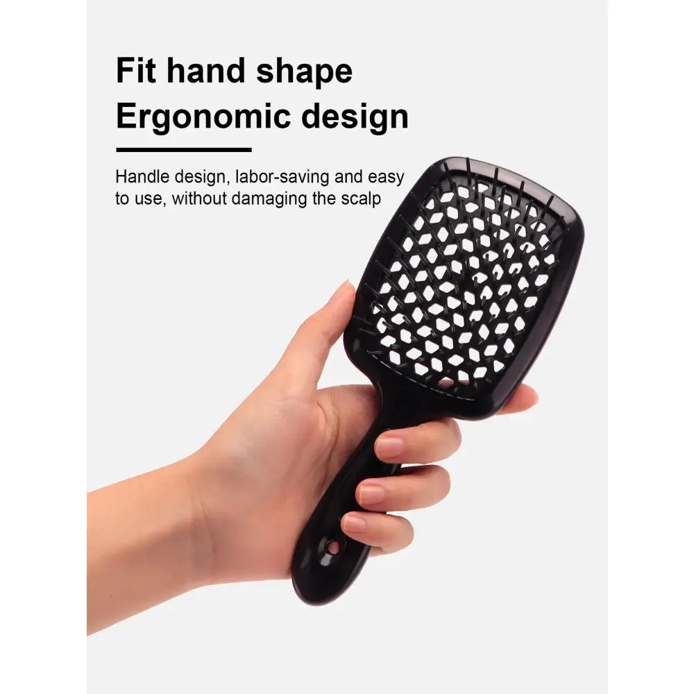 Ergonomic hairbrush with a paddle-style design and ventilation holes.