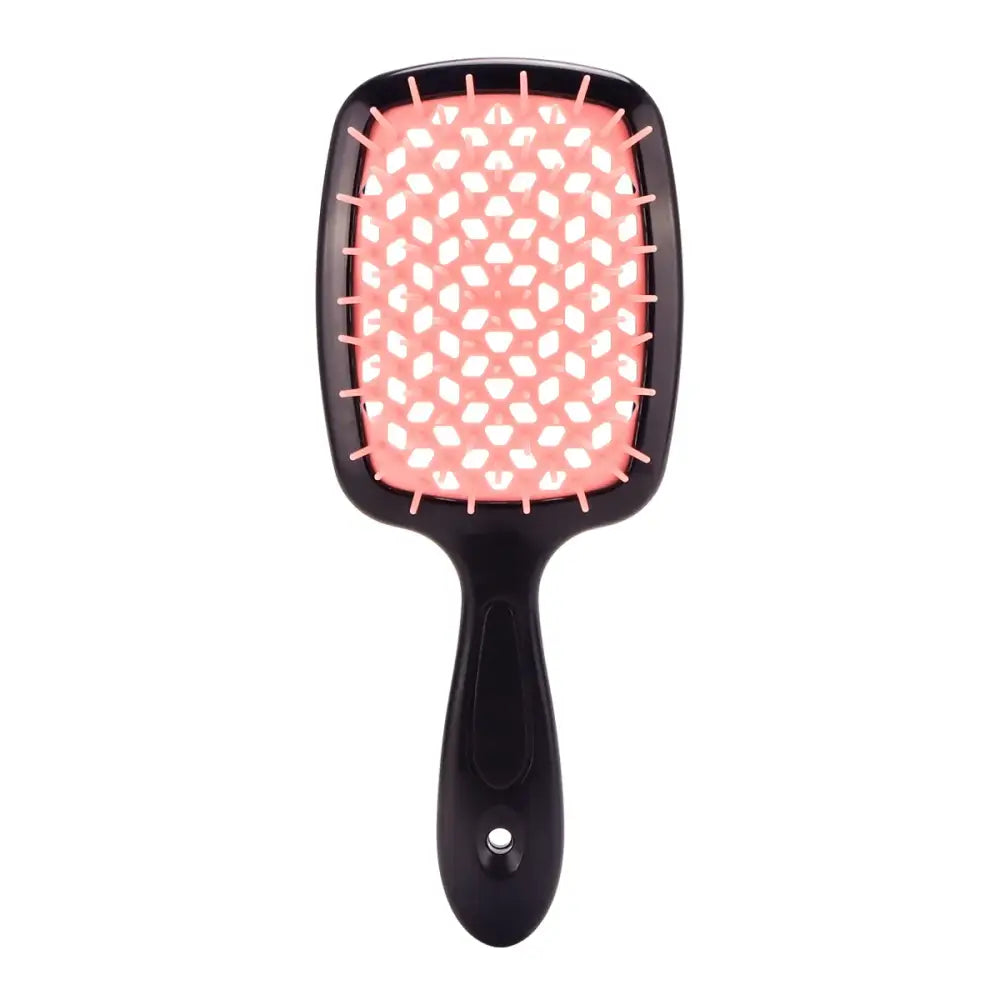 Paddle-style hairbrush with a pink and white polka dot cushion and black handle.