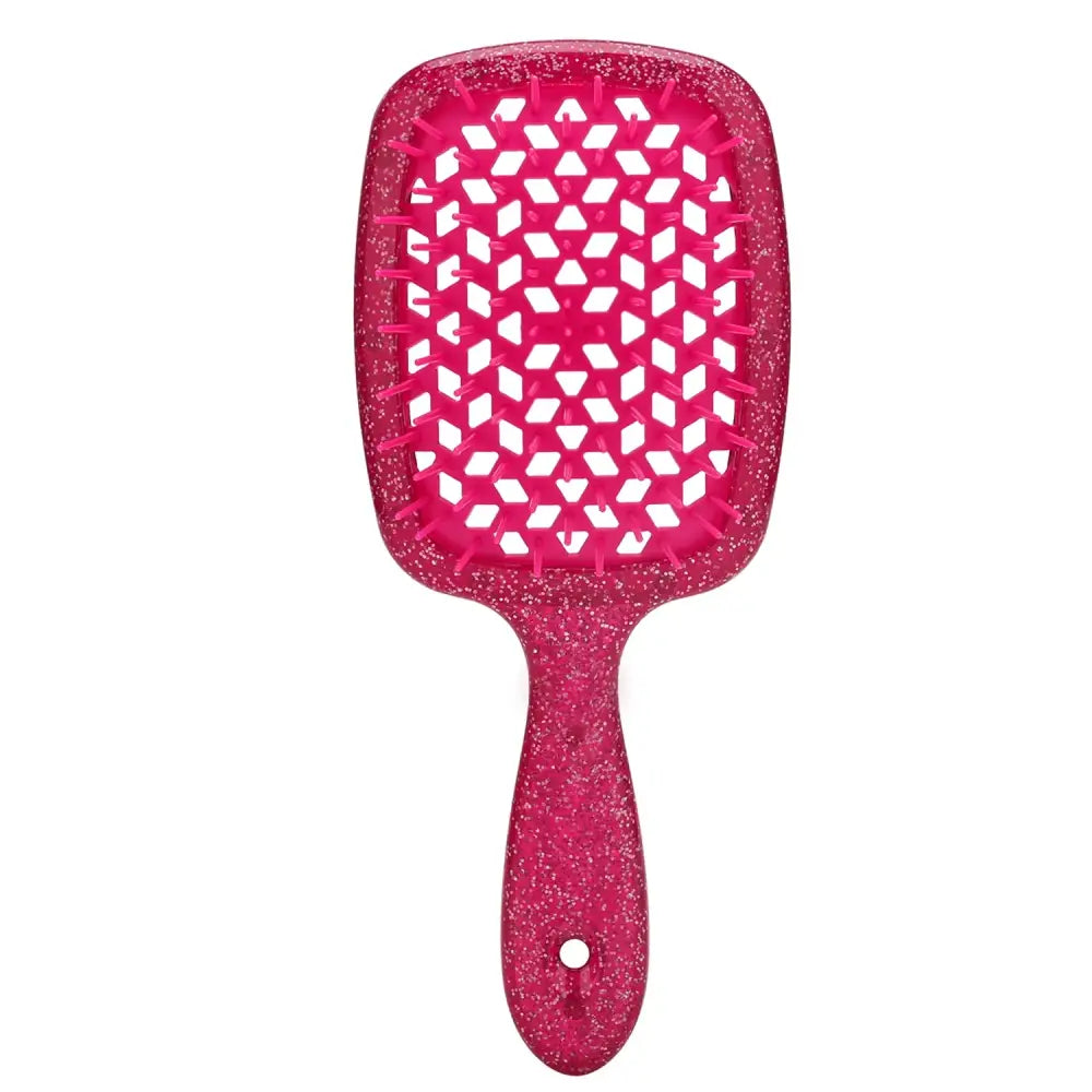 Pink glittery paddle hairbrush with a geometric pattern on its bristle surface.