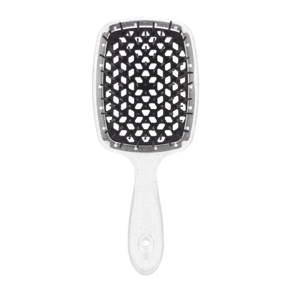 White hairbrush with a rectangular paddle featuring black and white geometric patterns.