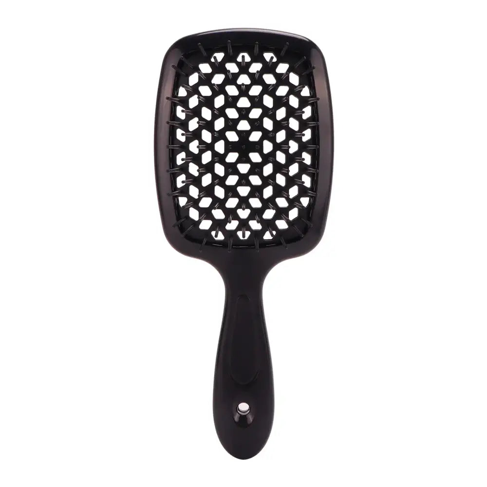 Black paddle hairbrush with white-tipped bristles arranged in a geometric pattern.