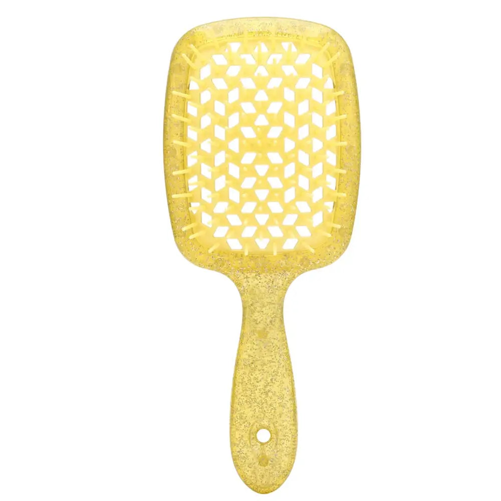 Yellow paddle hairbrush with a textured bristle area.