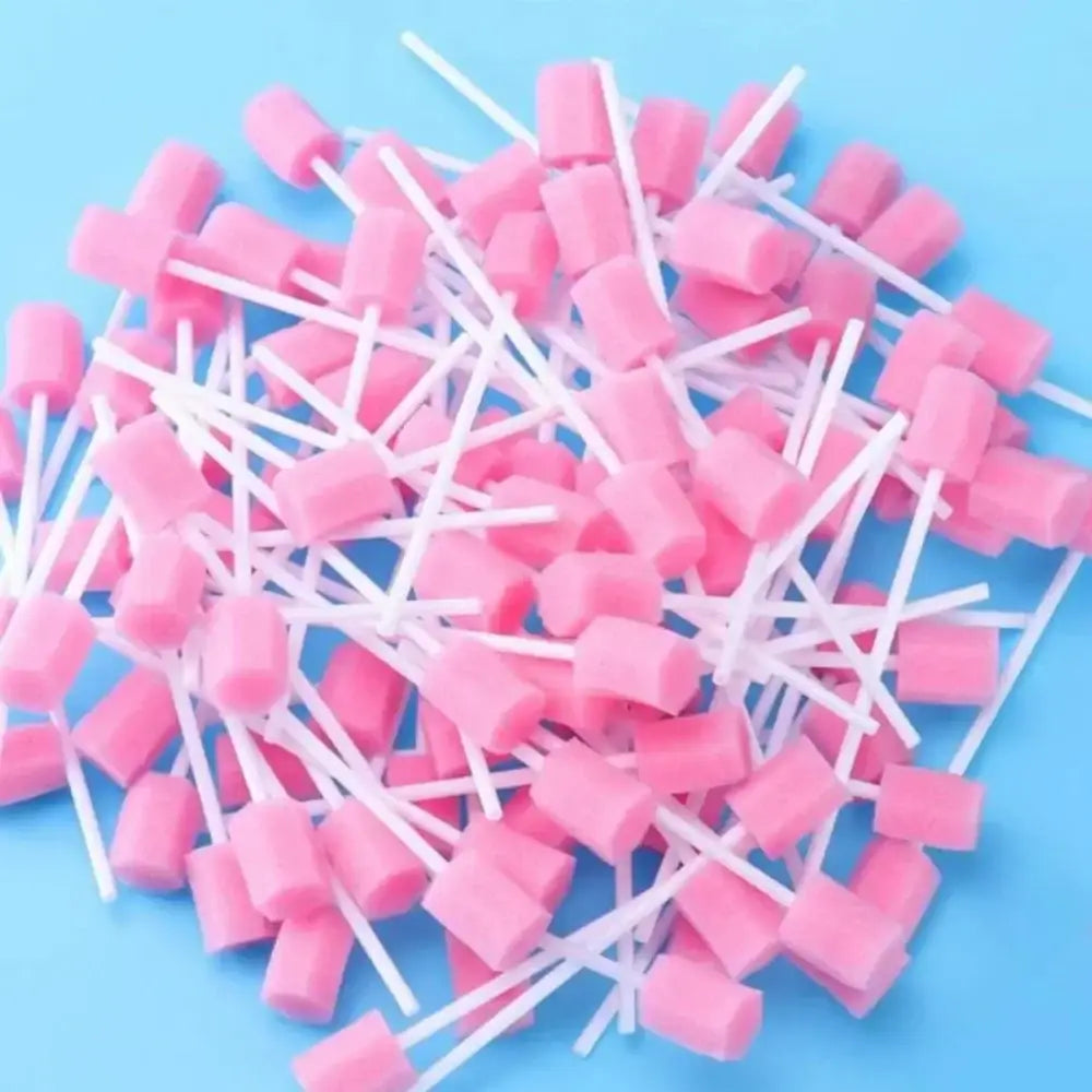 Pile of pink foam swabs or cleaning sticks with white handles.