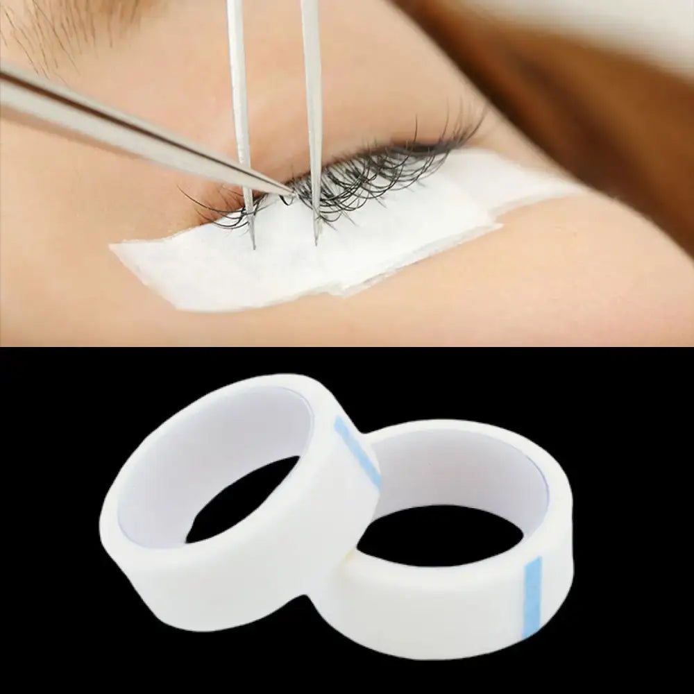 Eyelash extensions being applied with adhesive tape and tools.