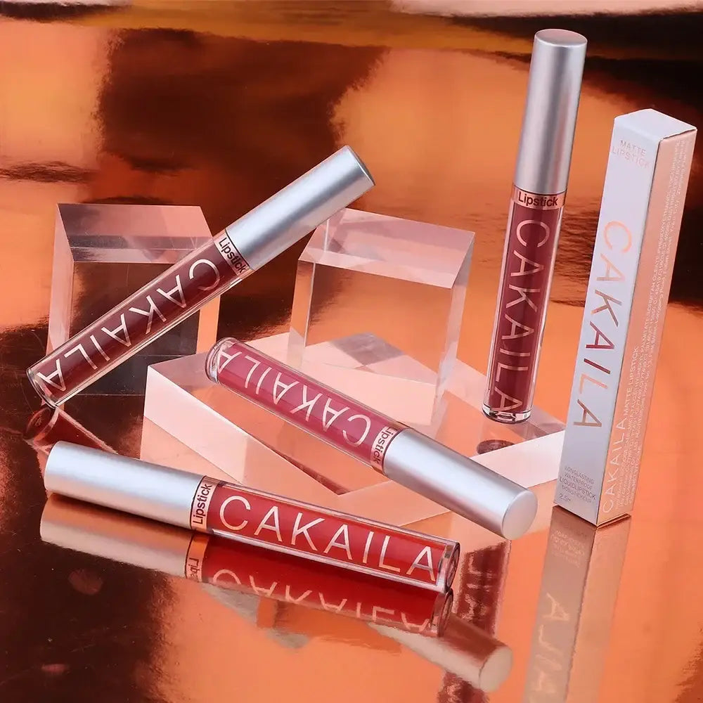 Cosmetic products from the brand Cakaila, including lipsticks or lip glosses in metallic tubes and boxes.