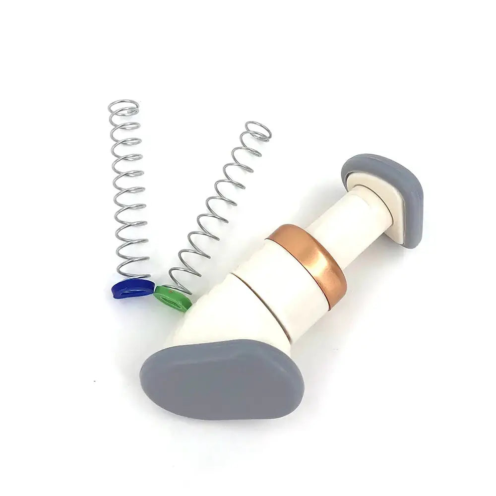 Handheld electronic device resembling a medical inhaler with springs and pills nearby.