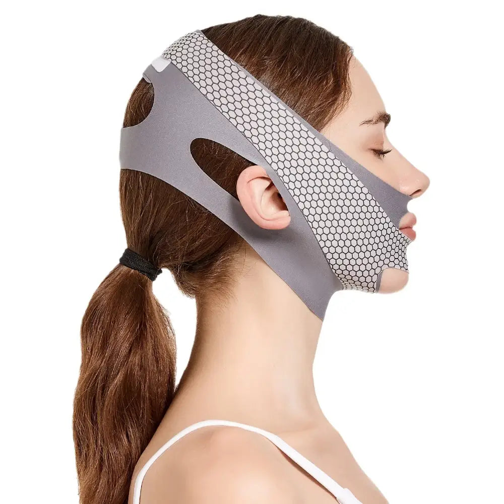 Facial compression garment or mask with perforated design worn by a person.