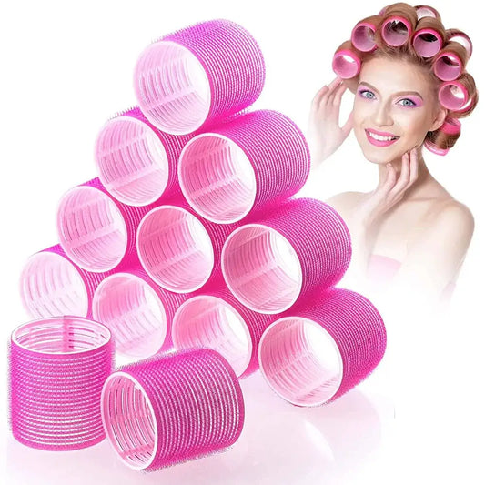 Pink hair rollers or curlers stacked in a pyramid formation.