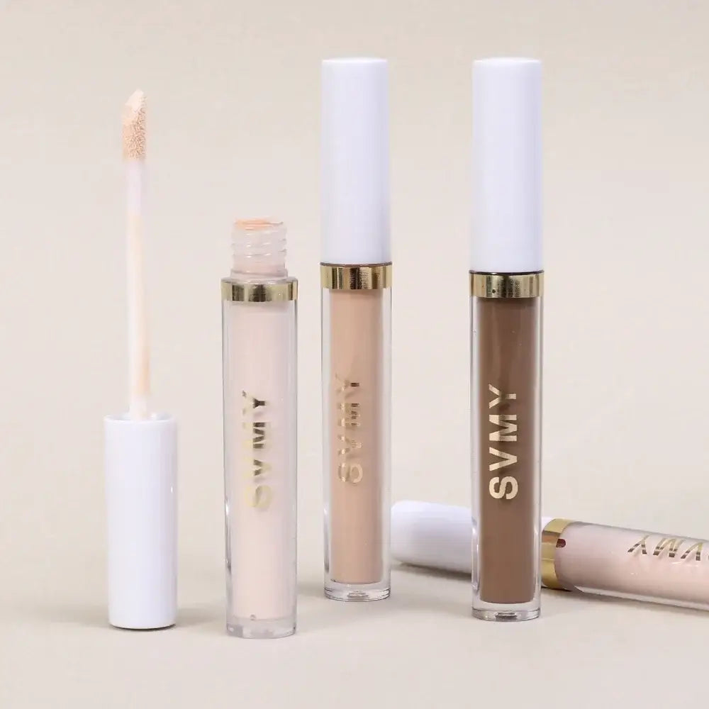 Cosmetic lip gloss tubes in various neutral shades.