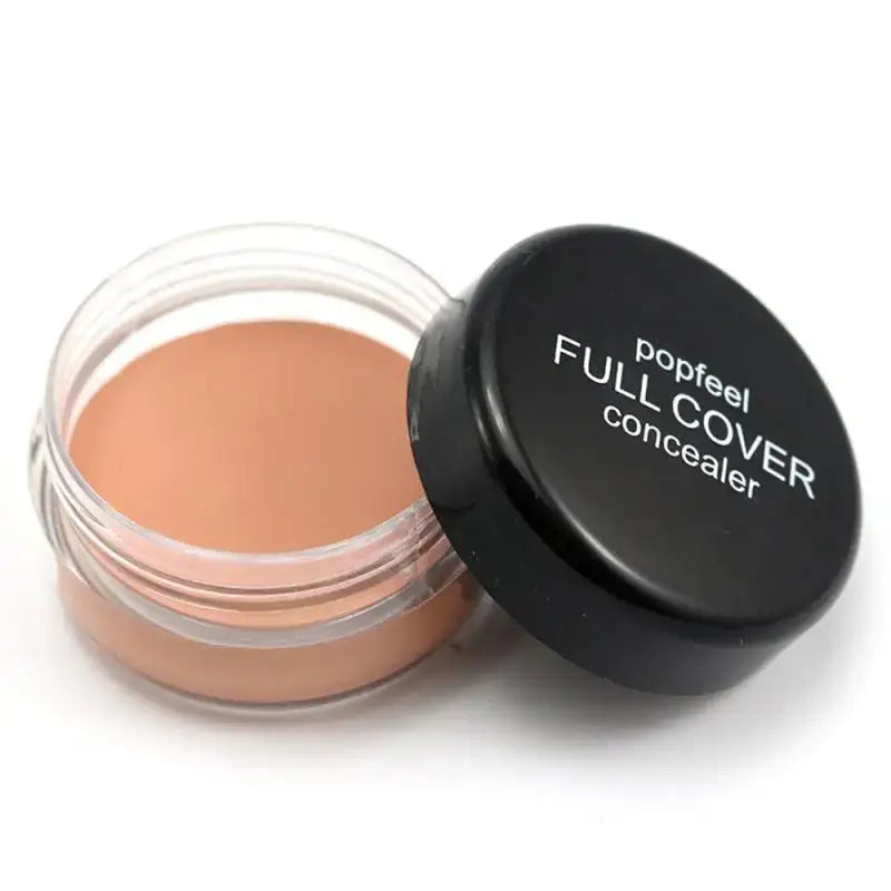 Jar of Full Cover concealer makeup with an open black lid.