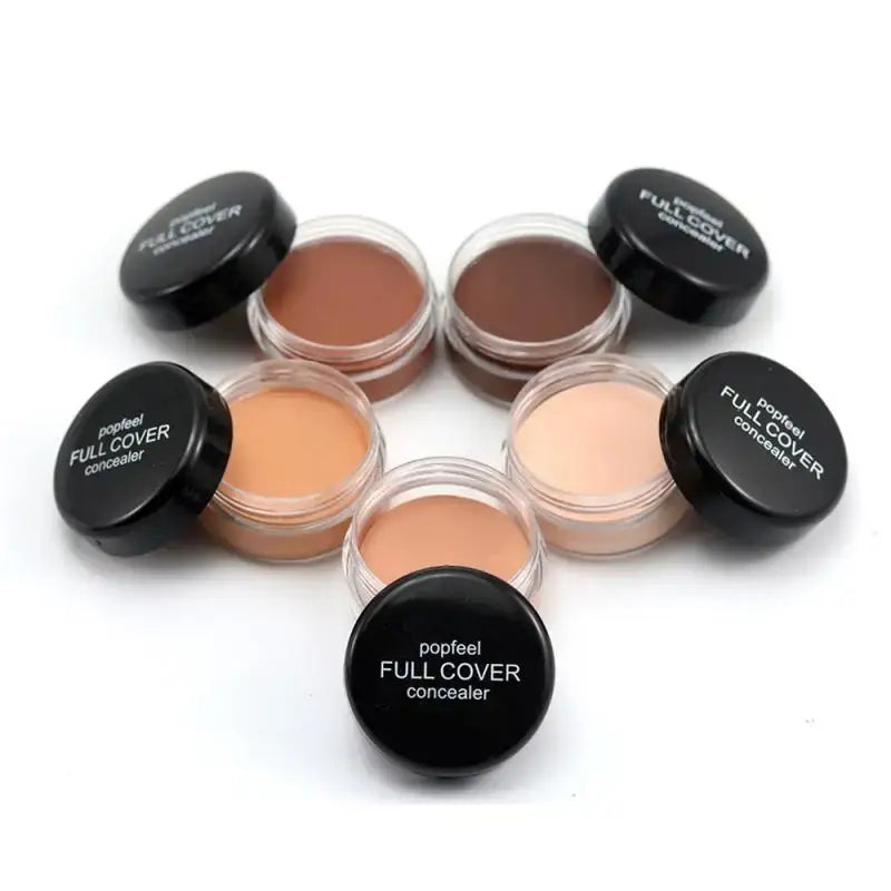 Set of full coverage concealers in various skin tone shades.