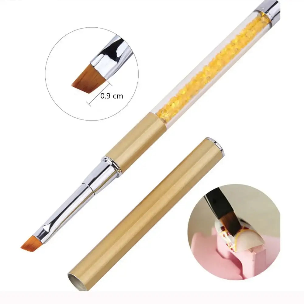 Nail art brush with a gold handle and crystal-filled transparent upper portion.