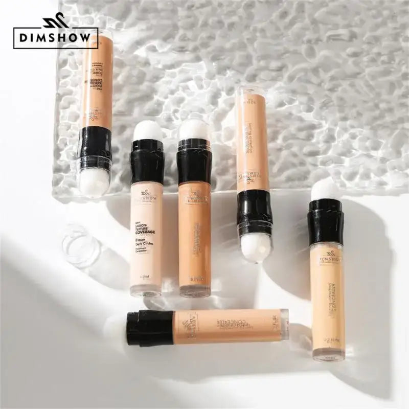 Collection of liquid makeup concealers or foundations in various shades.