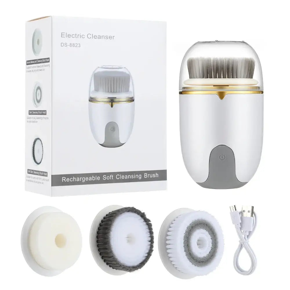 Electric facial cleansing brush with interchangeable brush heads and charging cable.