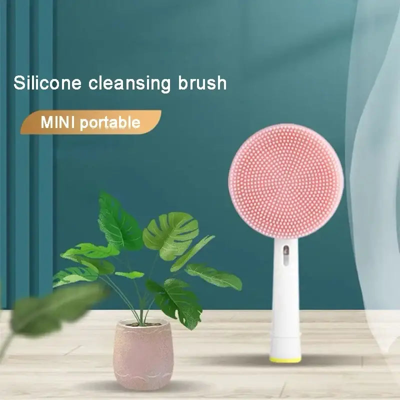 Pink circular silicone cleansing brush with a white handle.