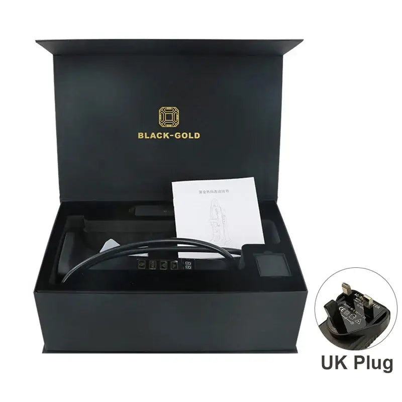 Black gift box containing an electronic device with a cord and UK plug.