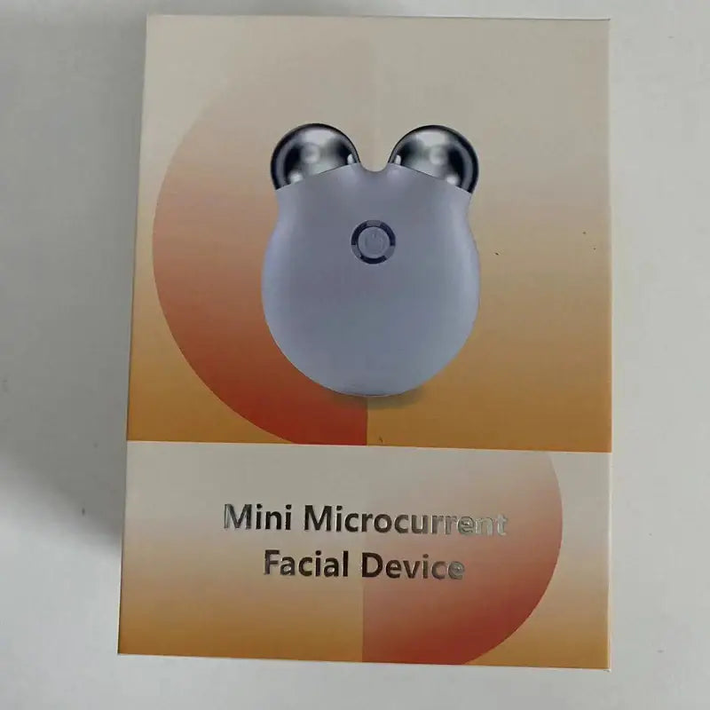 White, mouse-shaped facial device with two metallic spheres on top.