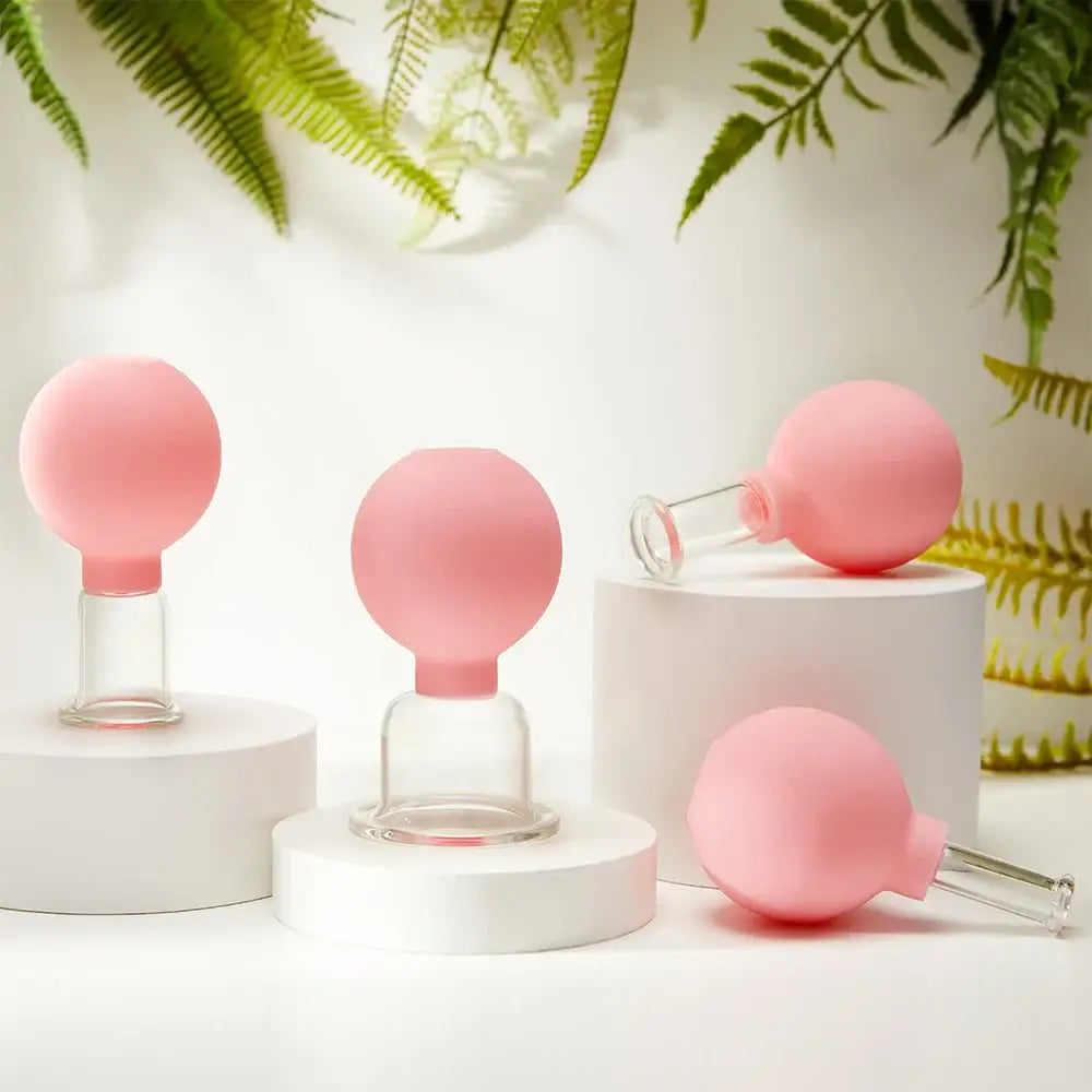 Pink silicone suction cups with glass handles.