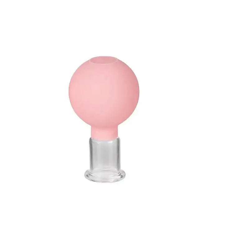 Pink spherical bulb atop a transparent cylindrical base.