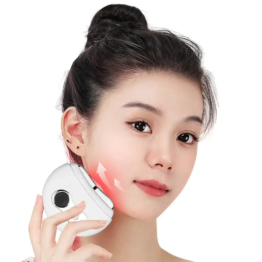 Handheld beauty device emitting red light held against a person’s cheek.