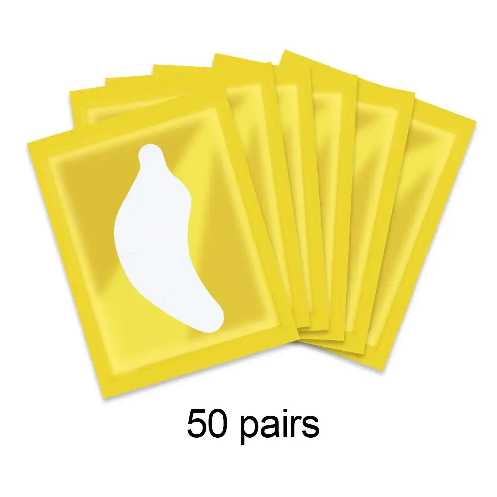 Yellow eye masks or patches with a banana-shaped cutout, packaged in pairs.