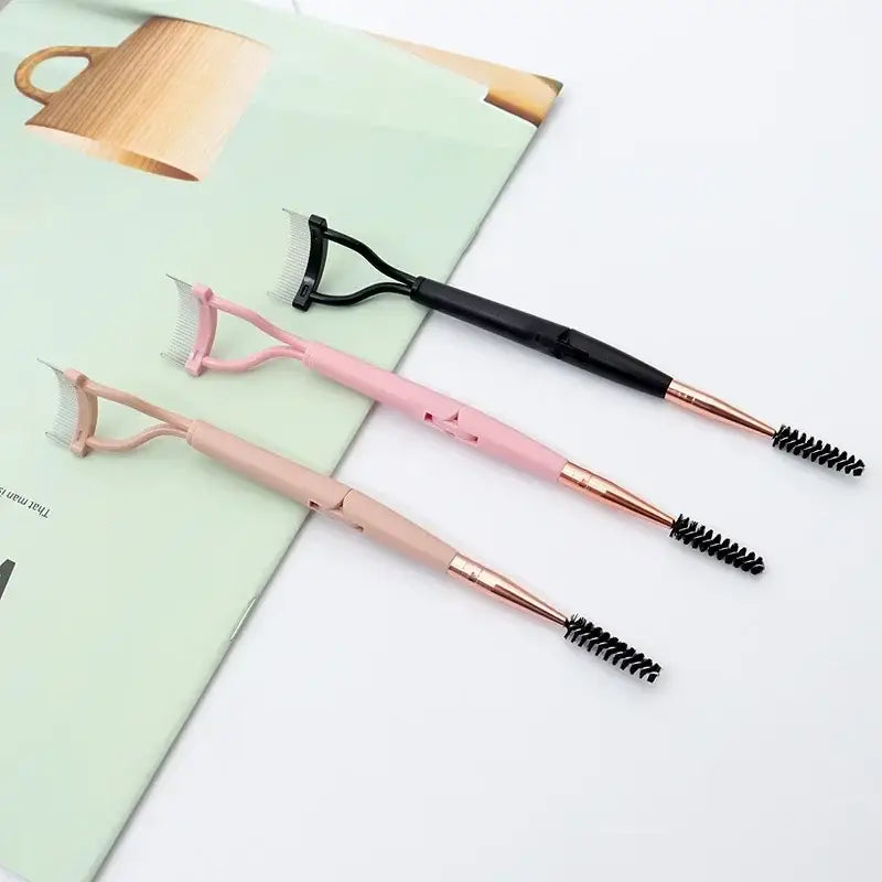 Eyebrow brushes with dual-ended design featuring spoolie and angled brush tips in pink and black colors.