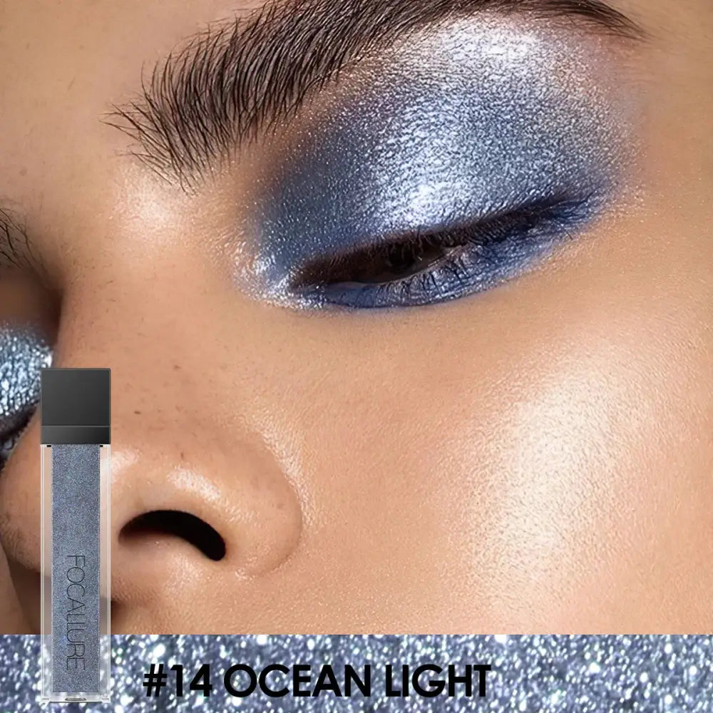 Close-up of an eye with shimmering blue and silver eyeshadow.