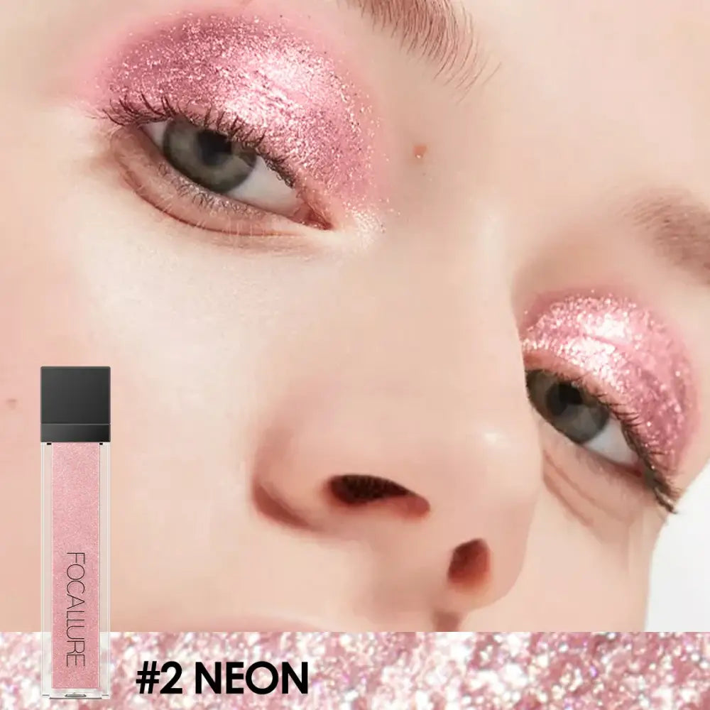 Close-up of eyes with shimmering pink eyeshadow, alongside a cosmetic product labeled ’#2 NEON’.