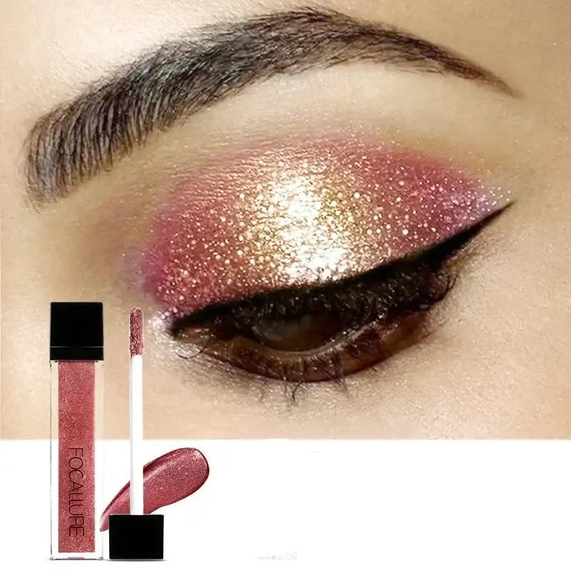 Closed eye with shimmering pink and gold eyeshadow and winged eyeliner.