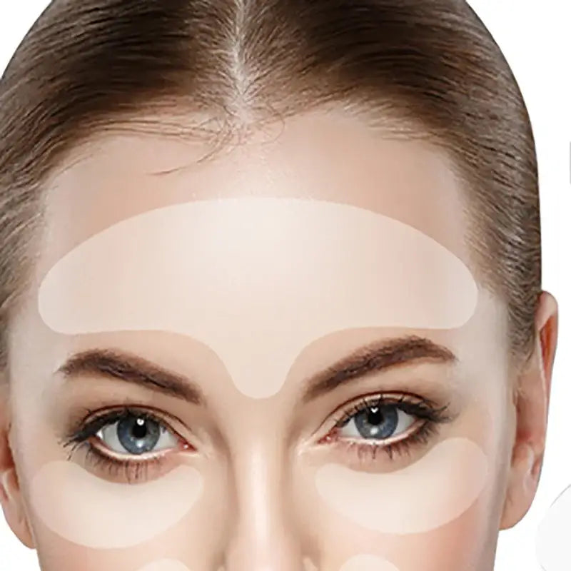 Close-up of a woman’s face with a light-colored cosmetic product applied to her forehead area.