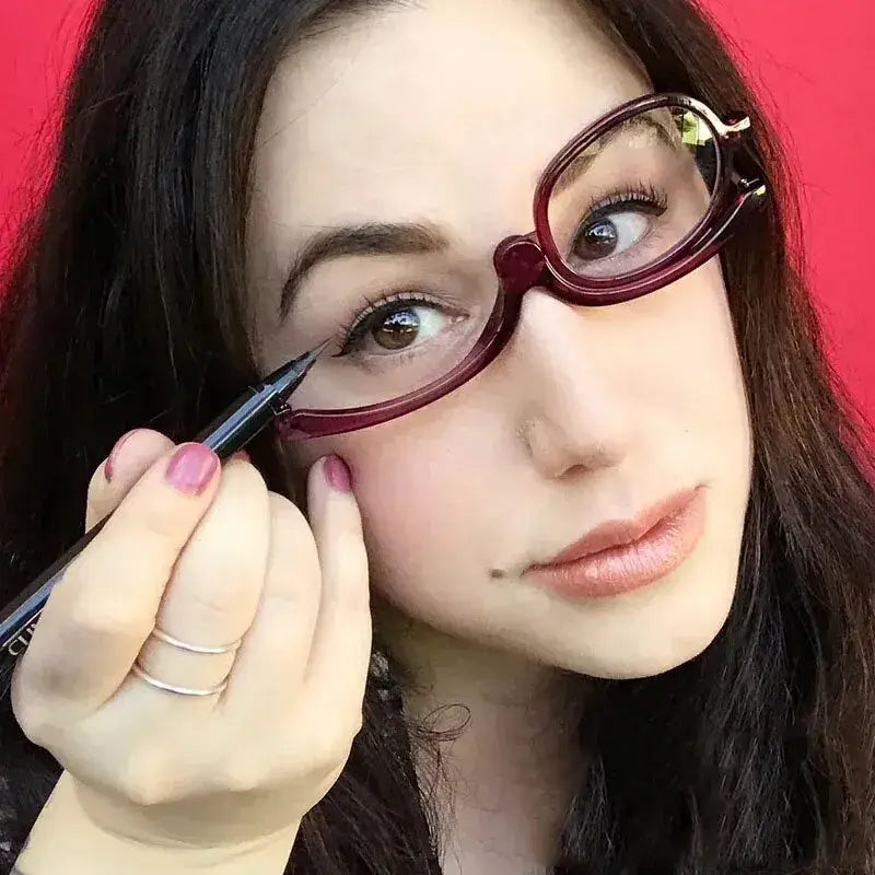 Burgundy-framed eyeglasses being adjusted on a woman’s face.