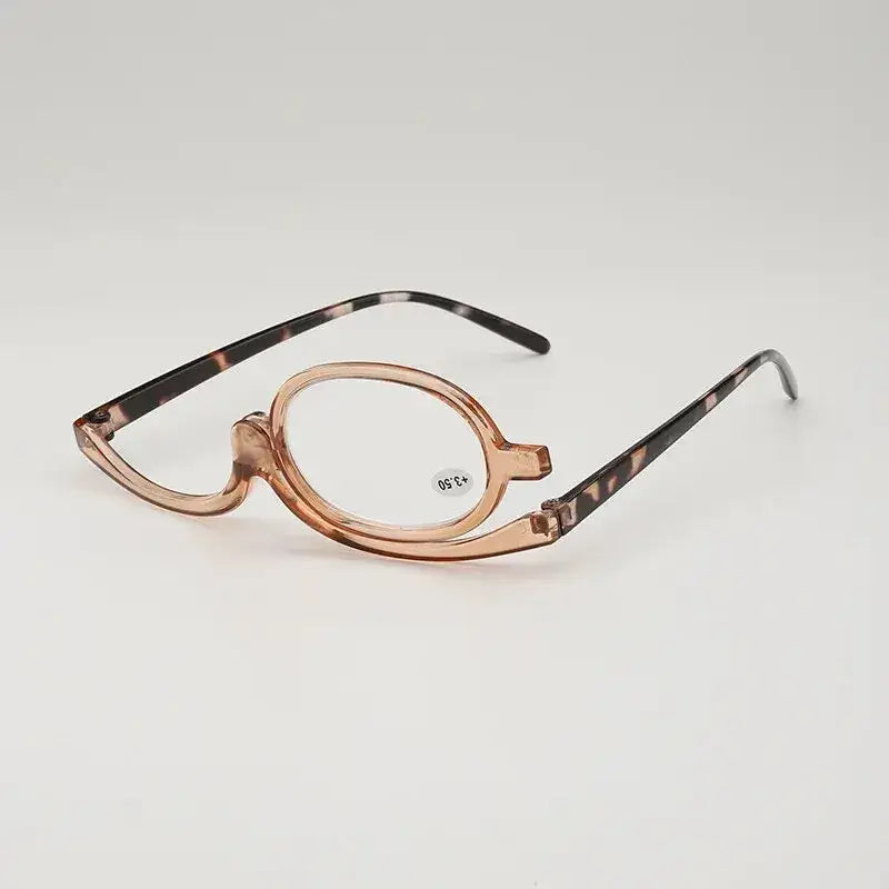 Unique makeup glasses with one magnifying lens for applying eye makeup.