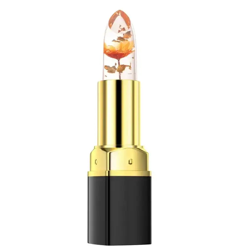 Lipstick with a clear cap containing a visible orange flower.