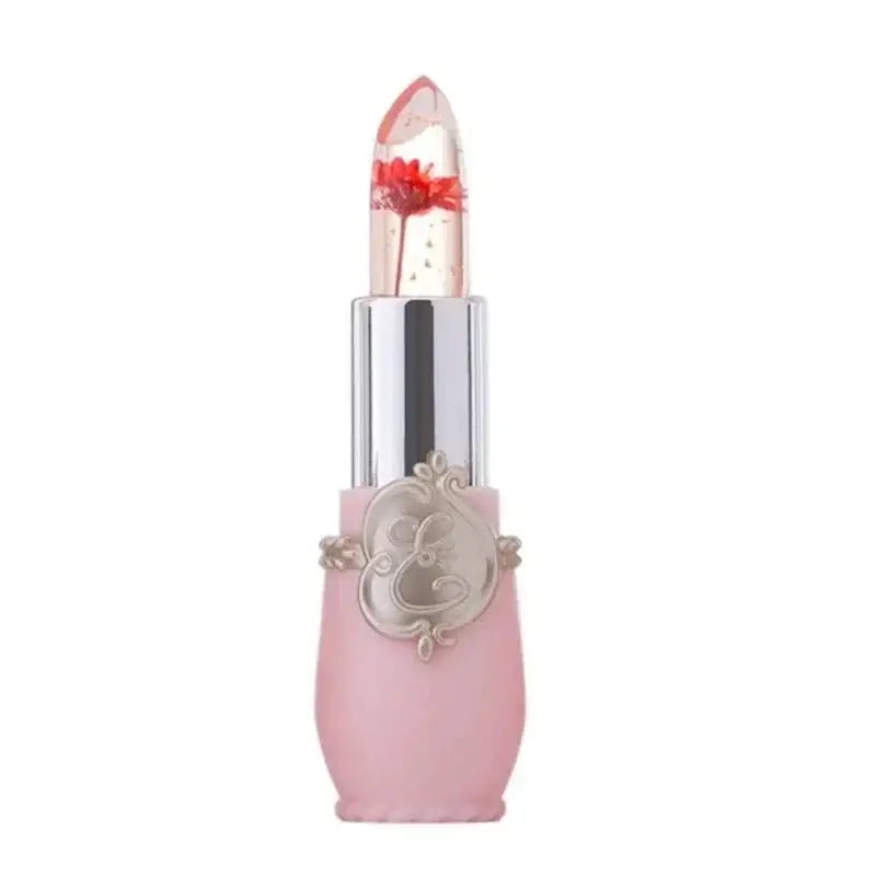 Decorative pink lipstick with a clear cap and ornate silver embellishment on the tube.