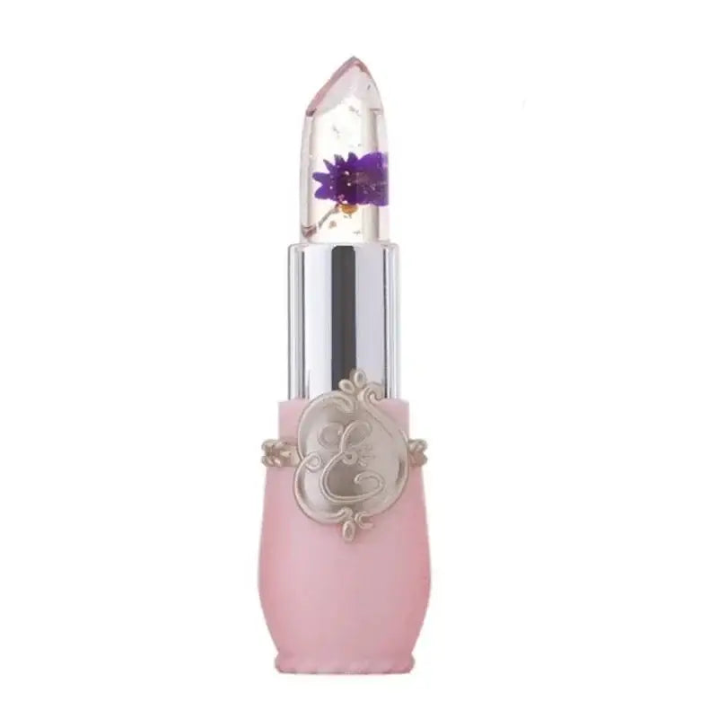 Decorative pink lipstick tube with a clear cap containing a purple flower.