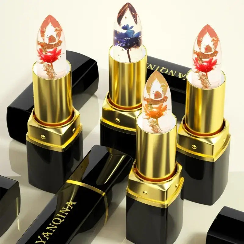 Lipsticks with flame-shaped tips in gold and black tubes.