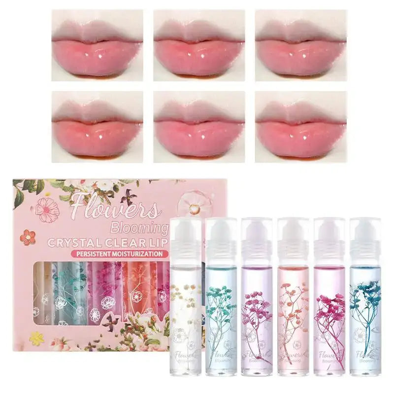 Set of colorful lip gloss products with floral-themed packaging.