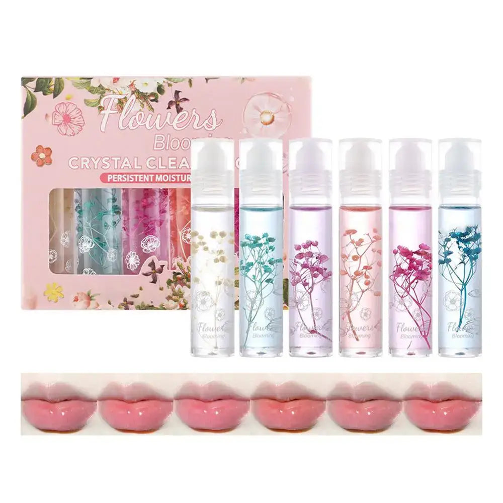 Set of floral-themed lip glosses with crystal-clear bottles containing colorful dried flowers.