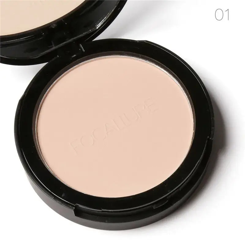 Compact powder makeup in a round black case with pale beige product visible.