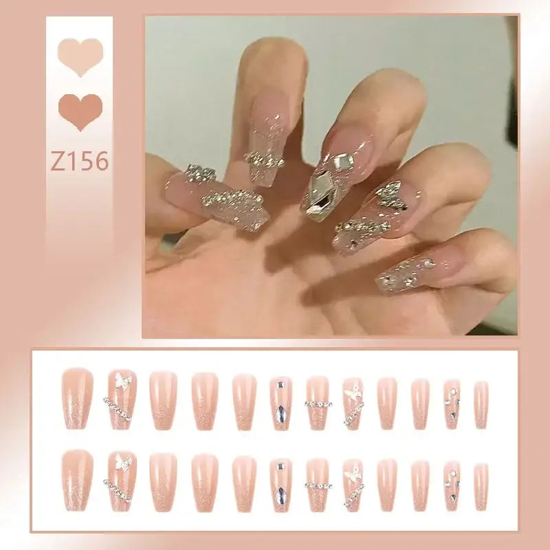 Elaborately decorated acrylic nails with glittery and crystal embellishments.