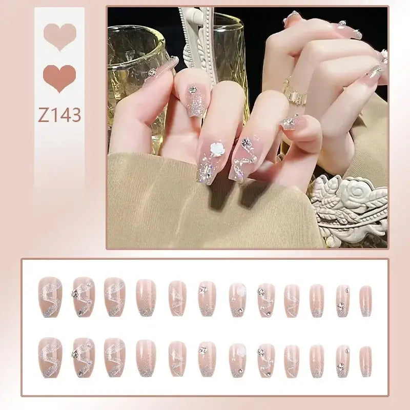 Elaborately manicured fingernails with glittery pink and silver designs.