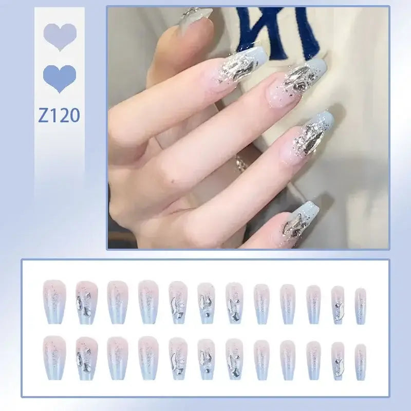 Elaborately decorated artificial nails with a silver and white marbled design.