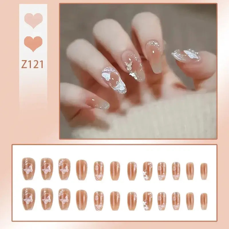 Elegant manicured nails with glittery and jeweled accents in a nude color palette.