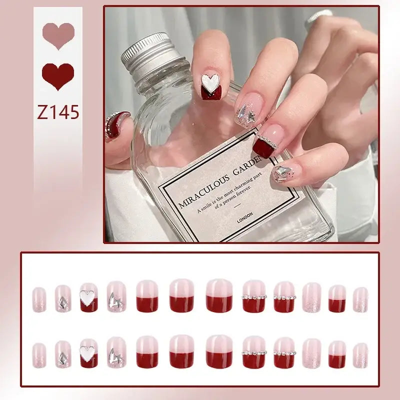 Hand holding a bottle of Gorgeous Garden gin, showcasing manicured nails with heart designs.