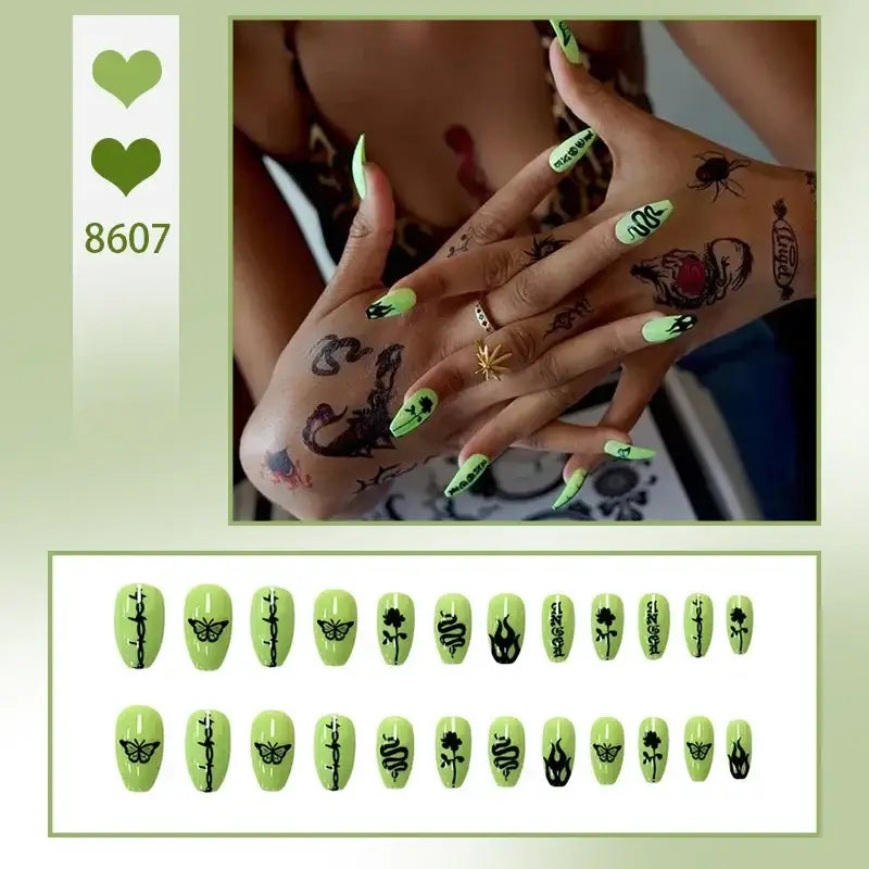 Hand with long, neon green nails decorated with alien-themed designs and temporary tattoos.