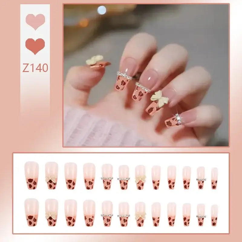 Manicured nails with heart-themed nail art designs.