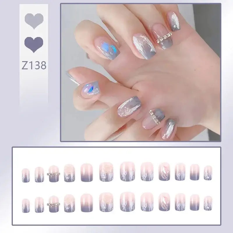 Manicured nails with pastel blue, silver, and pink nail art designs.