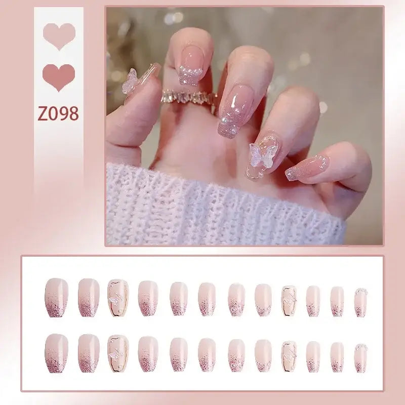 Manicured nails with delicate pink and glittery designs, accompanied by a decorative ring.